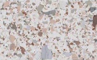 White terrazzo surface with small, irregular chips in shades of beige, brown, gray, and pink scattered throughout.